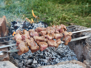 Cooking kebabs on an open fire. Food in nature.