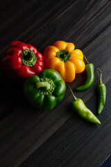 red and yellow peppers on wooden table