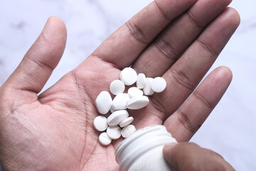 close up of pills on palm of hand