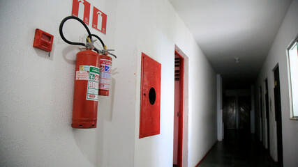 salvador, bahia / brazil - june 29, 2020: extinguisher for fire is seen in corridor of residential...