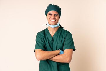 Surgeon man in blue uniform over isolated background laughing