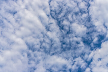 White clouds on a blue sky. Foam from clouds. Clear weather