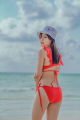 Young sexy woman in bikini enjoying summer vacation on beach relaxing holiday