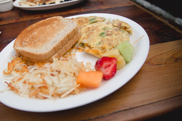 egg omelet breakfast with toast and fruit