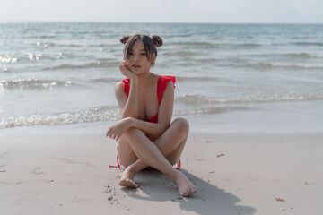 Fototapeta na wymiar Young sexy woman in bikini enjoying summer vacation on beach relaxing holiday