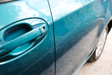 Obraz premium Scratch on a car body close-up. Damage to the paintwork.