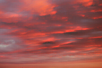 Orange sky background at sunset with heap thick clouds