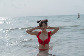 Fototapeta na wymiar Young sexy woman in bikini enjoying summer vacation on beach relaxing holiday