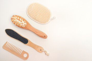Concept eco theme, set of bathroom accessories made from natural materials. Wood brushes and combs on a white background, zero waste.