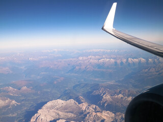 Fototapeta na wymiar View from plane window on Planet Earth, Alps Mountains.