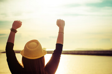 Fototapeta premium Close up of young woman enjoying victory and rise the hand and scream, enjoy success.