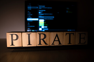 Pirate words on wooden cubes on laptop.