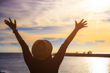 Silhouette of young woman enjoying victory and rise the hand and scream, enjoy success.