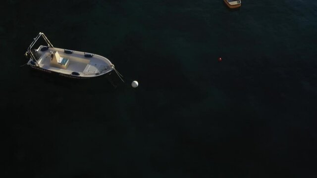 Aerial shot over some boats floating in the sea, in "Conca dei Marini", Amalfi Coast
