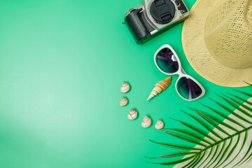The beach accessories on the green background. Summer is coming concept. vacation and travel concept.