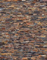 wall of dark brown, natural slate stone