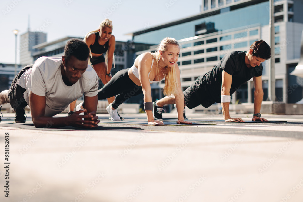 Sticker fitness group working out together in the city