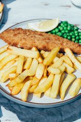 Traditional English Food such as Fish and Chips with green peas served in the Pub or Restaurant