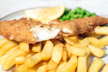 Traditional English Food such as Fish and Chips with green peas served in the Pub or Restaurant