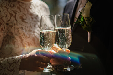 Bride and groom holding champagne glass
