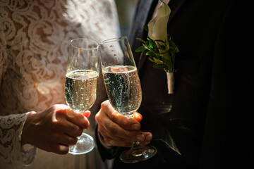 Bride and groom holding champagne glass