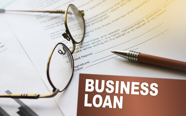 Business loan words on a card, Agreement with pen and glasses. Selective focus. Business work...
