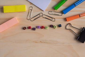 Education Text with school stationery on wooden table