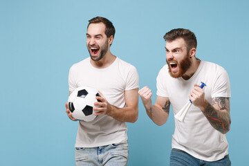Crazy men guys friends in white t-shirt isolated on pastel blue background. Sport leisure concept. Mock up copy space. Cheer up support favorite team with soccer ball pipe doing winner gesture scream.