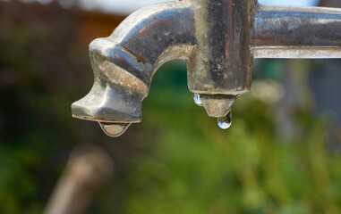 Water flows from a metal tap