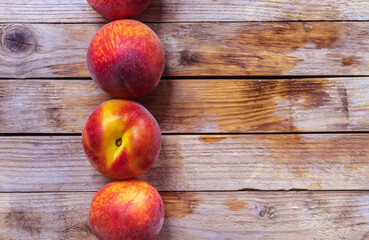 Fresh and healthy fruit on a wooden table - peaches