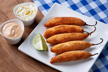 .Peppers stuffed with cheese, breaded and fried. Accompanied with curd, rose sauce and lemon