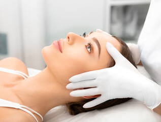 Obraz na płótnie Canvas Beautiful woman, with smooth, shiny skin and a clean face, after peeling and skin rejuvenation, Refreshing skin masks, at the beautician