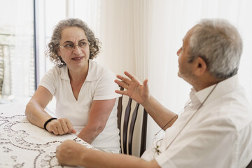 Old aged, Turkish, happy senior couple enjoying time together, looking to each other, laughing,...