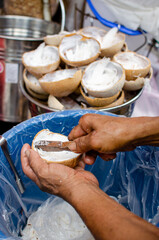 man grating coconut
