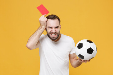Dissatisfied man guy football fan in white t-shirt isolated on yellow background. People sport...