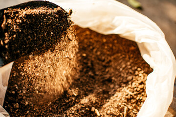 Shovel gardener and organic fertilizer or manure in the bag. Material for planting seeds and agriculture concept.