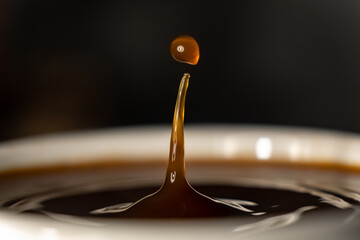 coffee splash and drop . macro close up brown liquid with smoke.