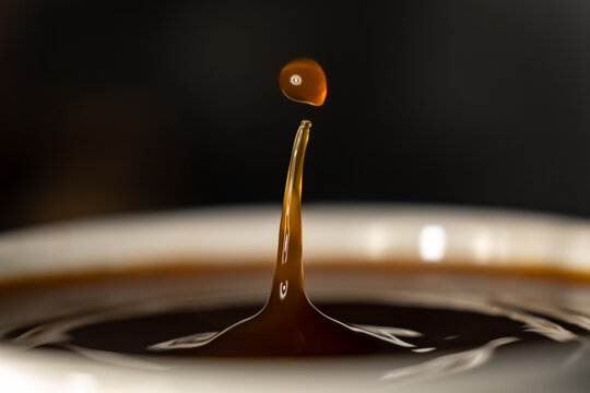 Coffee Splash And Drop . Macro Close Up Brown Liquid With Smoke.