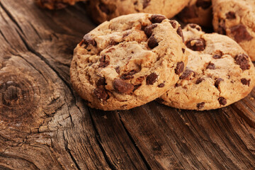 Chocolate cookies on wooden table. Chocolate chip cookies shot on vintage background