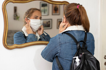 woman with a chinstrap preparing to go outside and protecting herself against covid 19