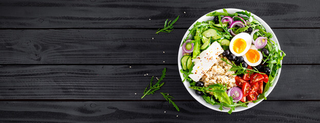 Greek style healthy breakfast bowl with oatmeal porridge and fresh vegetable salad of lettuce,...