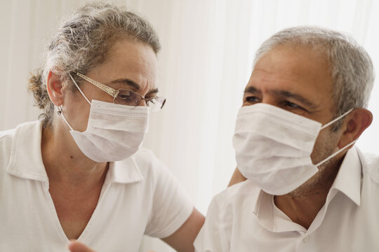 Sad Looking Old Couple Wearing Masks