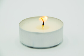 Fototapeta na wymiar burning wax candle on gray background