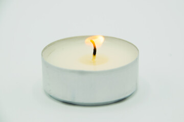 burning wax candle on gray background
