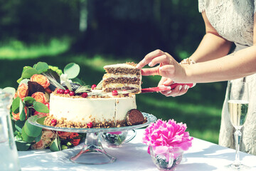 bride cutting slice of wedding cake