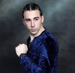 Attractive male model with braids posing in studio. Avantgarde, style, fashion concept.