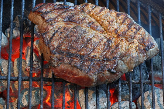 Beef Chuck Steak Being Cooked On A Charcoal Grill
