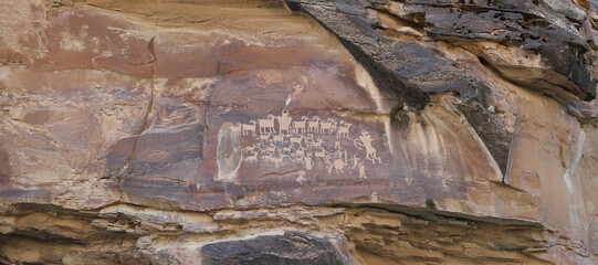Ancient Native American Indian rock art petroglyph great hunt Utah panorama. Nine Mile Canyon,...