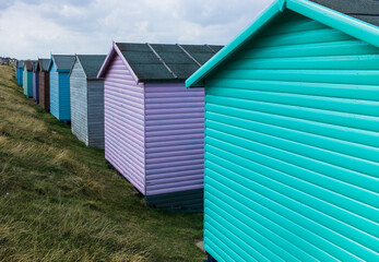Fototapeta na wymiar Traditional colorful English beach huts in Whitstable, Kent in the United Kingdom