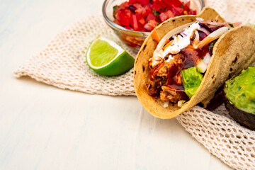 Mexican traditional authentic homemade tacos with pulled pork beef chili con carne serve with...